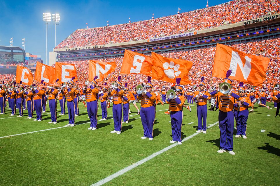 Marching band performing under stadium lights